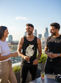 Latino male model wearing the Whale King Tank at a rooftop day party with friends